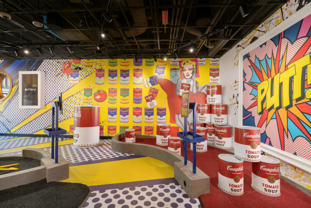 Puttery Kansas City indoor mini golf course with bright pop-art design, bold colors, and playful putting obstacles