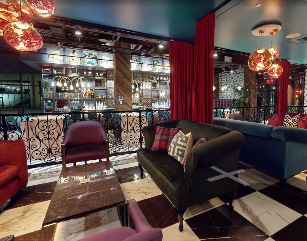 Colorful lounge seating overlooking a full-service bar at Puttery Minneapolis.
