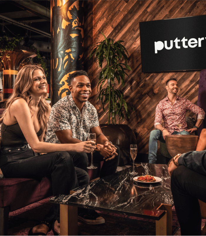 http://A%20lively%20group%20of%20friends%20shares%20laughs%20over%20gourmet%20bites%20and%20drinks%20in%20Puttery's%20chic%20lounge%20setting.