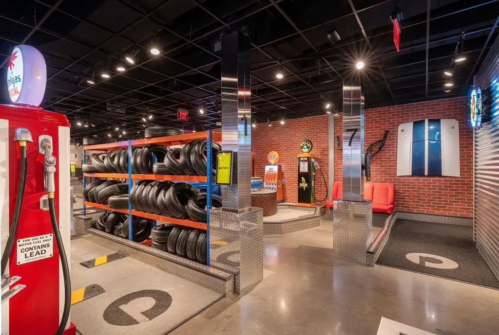 Garage Course at Puttery Pittsburgh with vintage gas pump, stacked tire rack, brick walls and automotive-themed decor.
