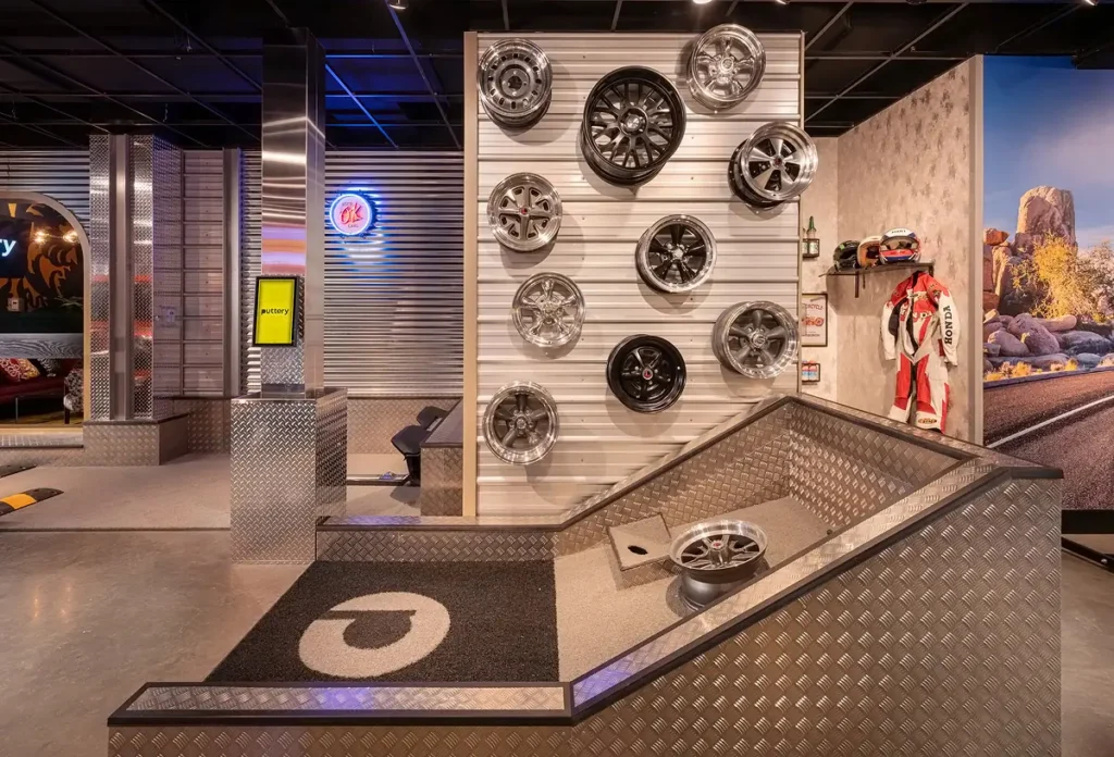 Wheel wall on the Garage Course at Puttery Pittsburgh with mounted rims, industrial finishes and automotive-themed mini golf features.