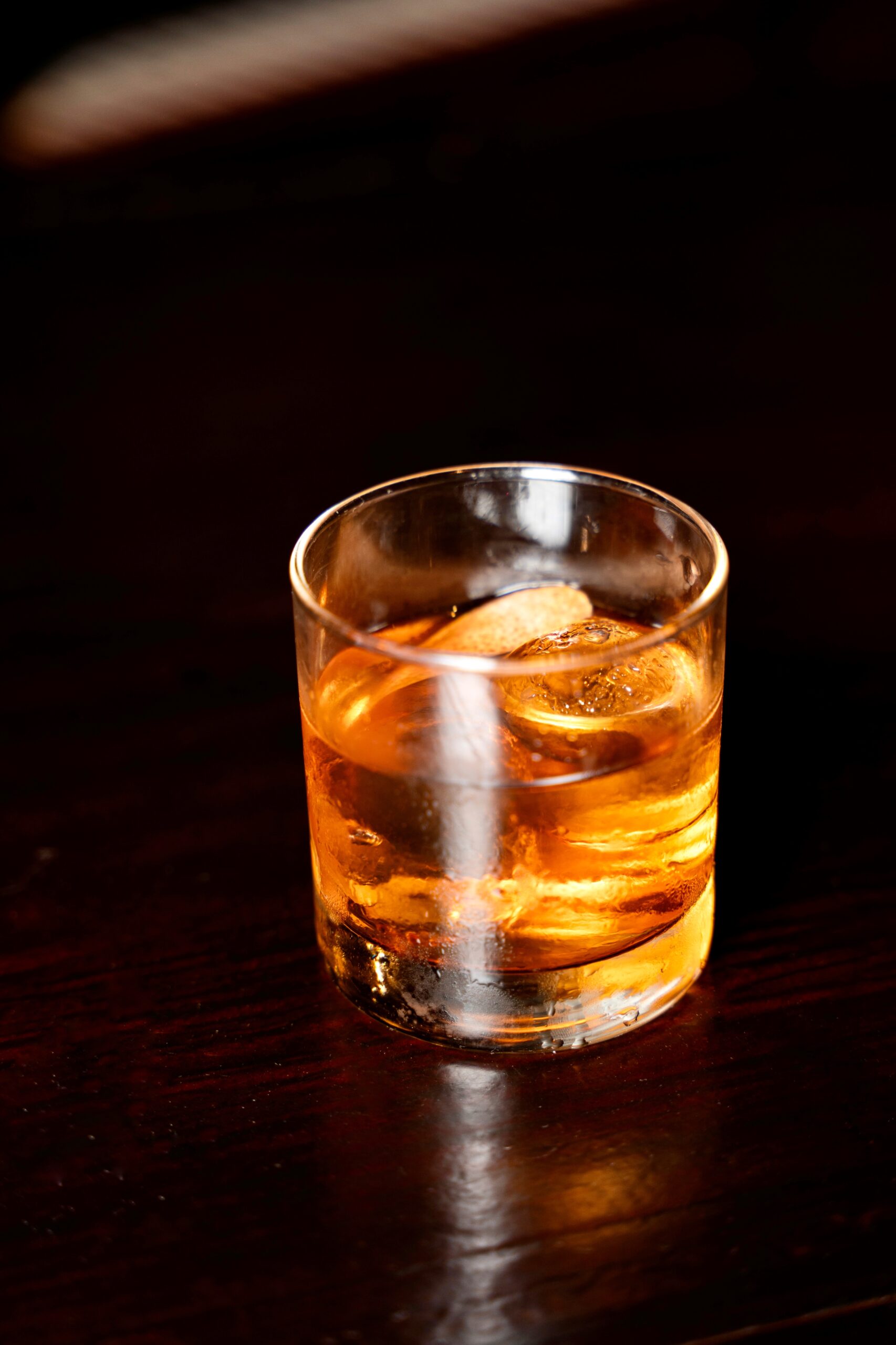 Golden hues of the luxurious Champions Old Fashioned at Puttery with ambient lighting.