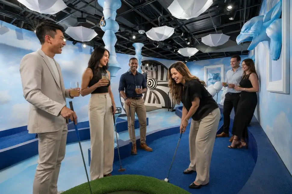 Corporate group playing mini golf at Puttery The Colony, a corporate event venue in Dallas.
