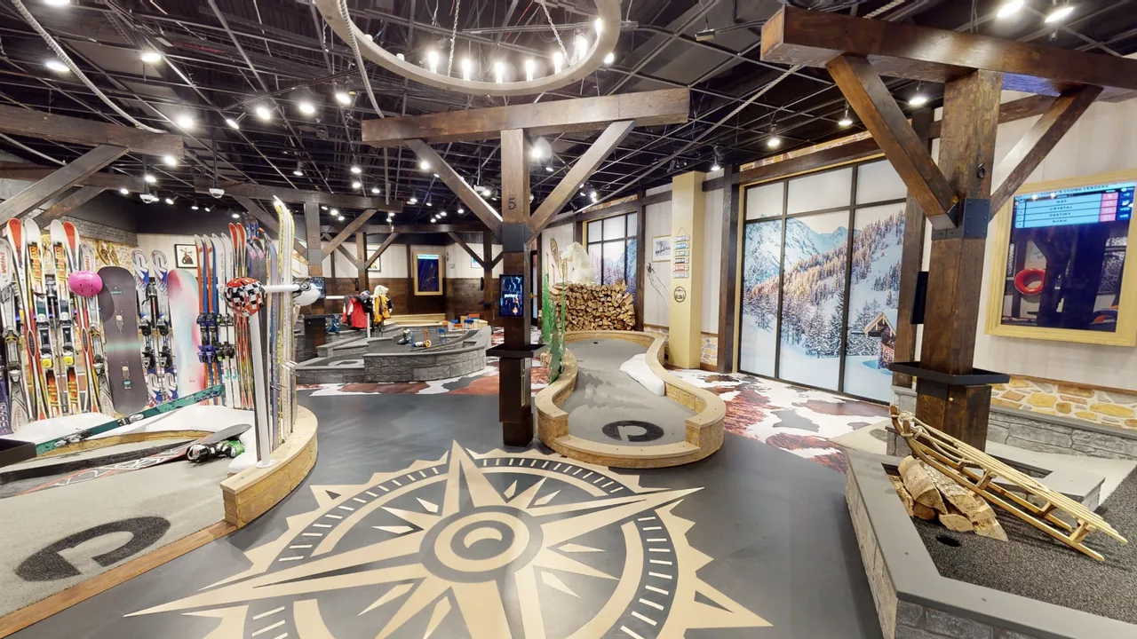 Ski-lodge-themed indoor mini golf course at Puttery Houston with skis, snowboards, timber beams and mountain scenery.