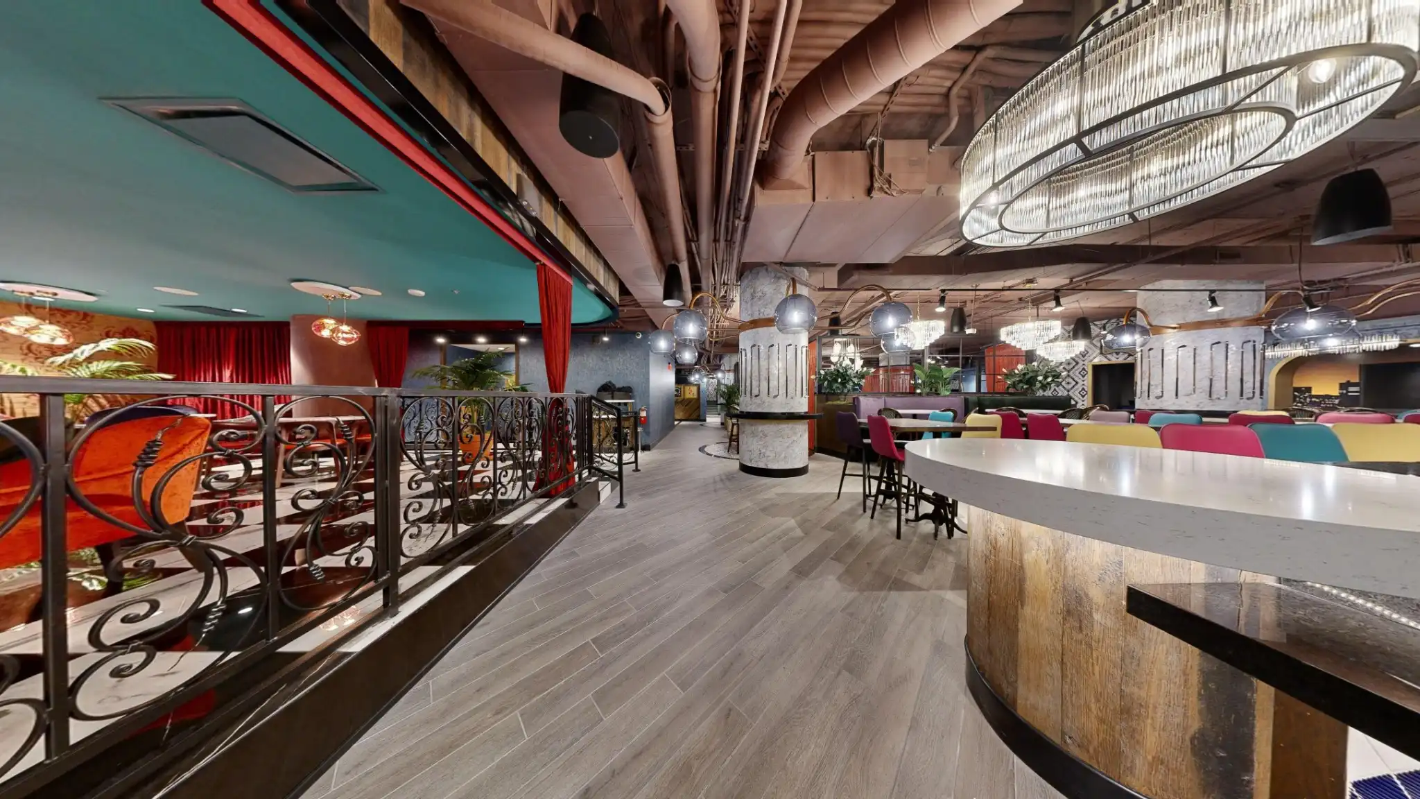 Puttery Kansas City dining and event space with chandeliers, communal tables and colorful seating.