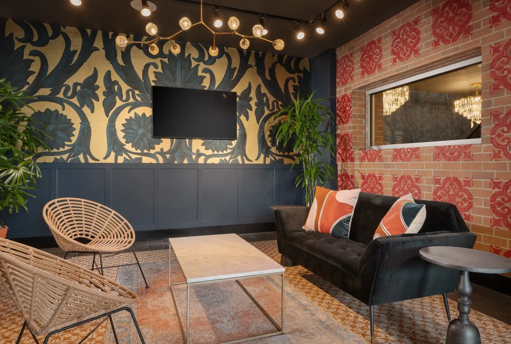 A cocktail lounge at Puttery Washington DC with red sofas, copper pendant lights, striped flooring, dining tables and large windows. The image reflects the venue’s vibrant interior design and energetic hospitality setting.