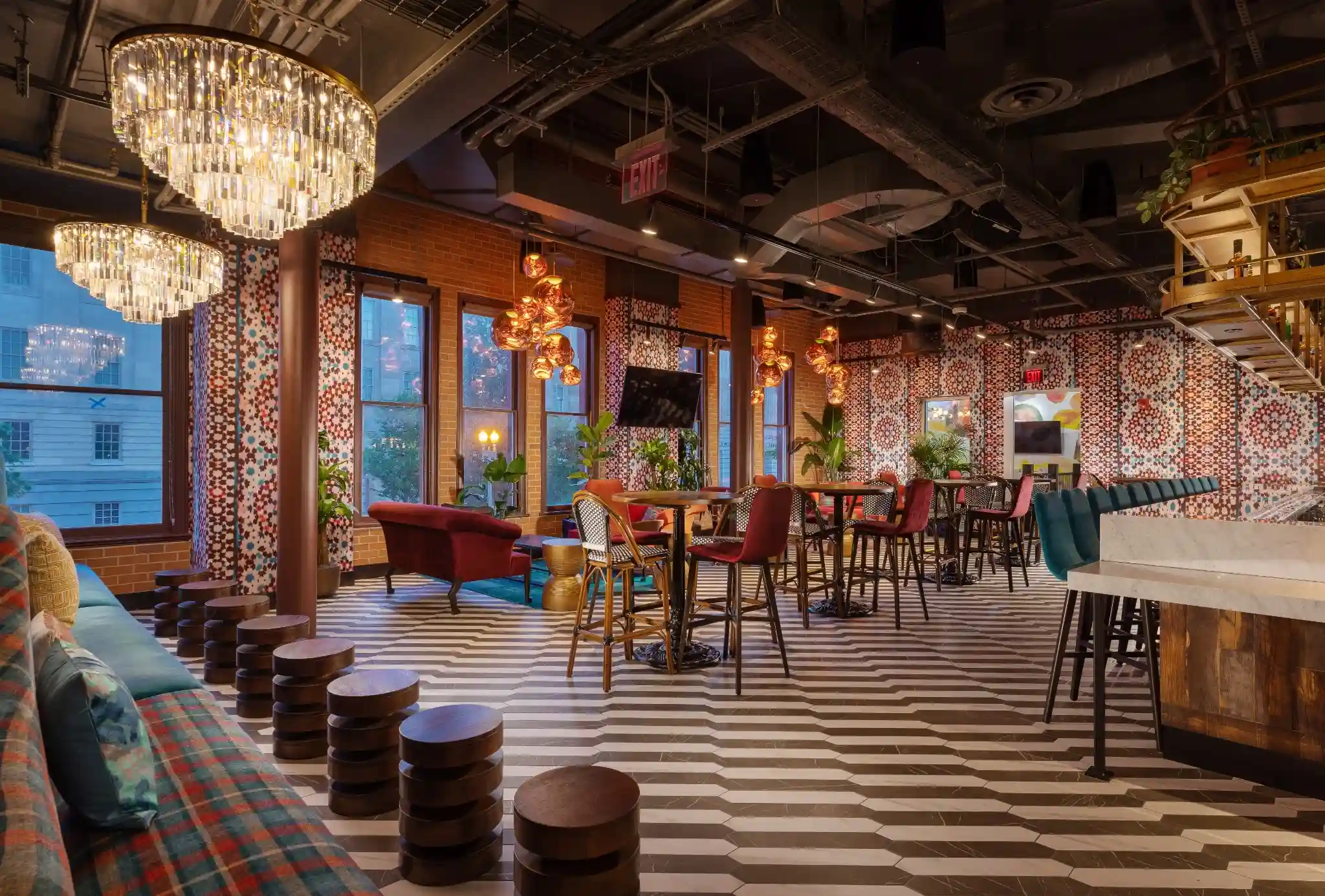 Lounge and cocktail seating at Puttery Washington DC with striped floors, chandeliers and patterned walls.