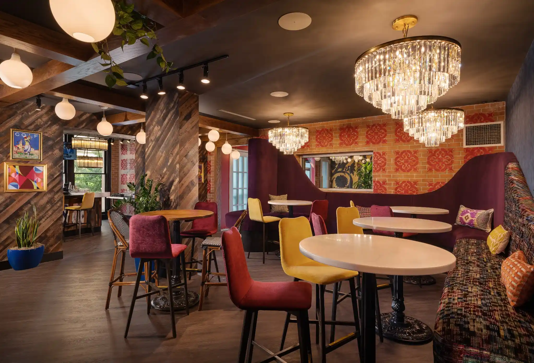 Lounge dining room at Puttery Washington DC with colorful seating, chandeliers and curved banquettes.