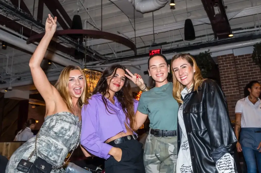 Four friends posing together during a night out at Puttery Miami in Wynwood.