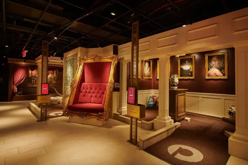 Ornate portrait gallery and oversized red throne on the History Museum Course at Puttery New York City.