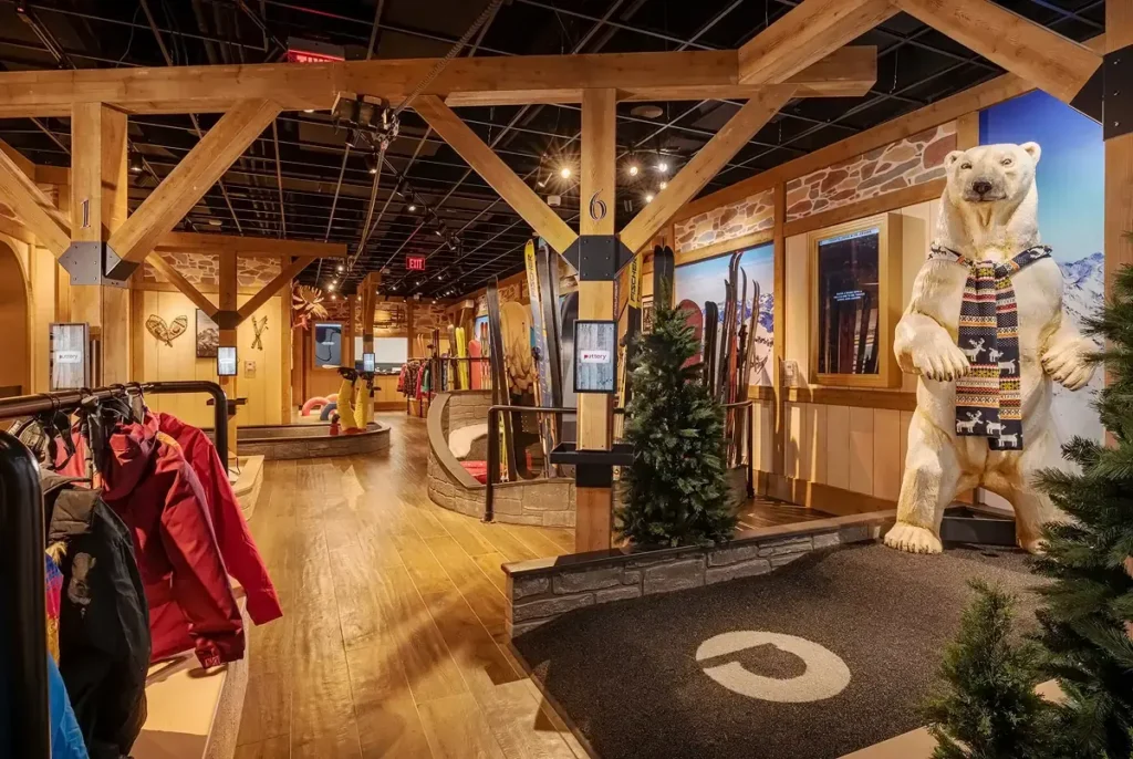 Polar bear figure, ski gear, timber beams, and mini golf lanes on the Lodge Course at Puttery Pittsburgh.